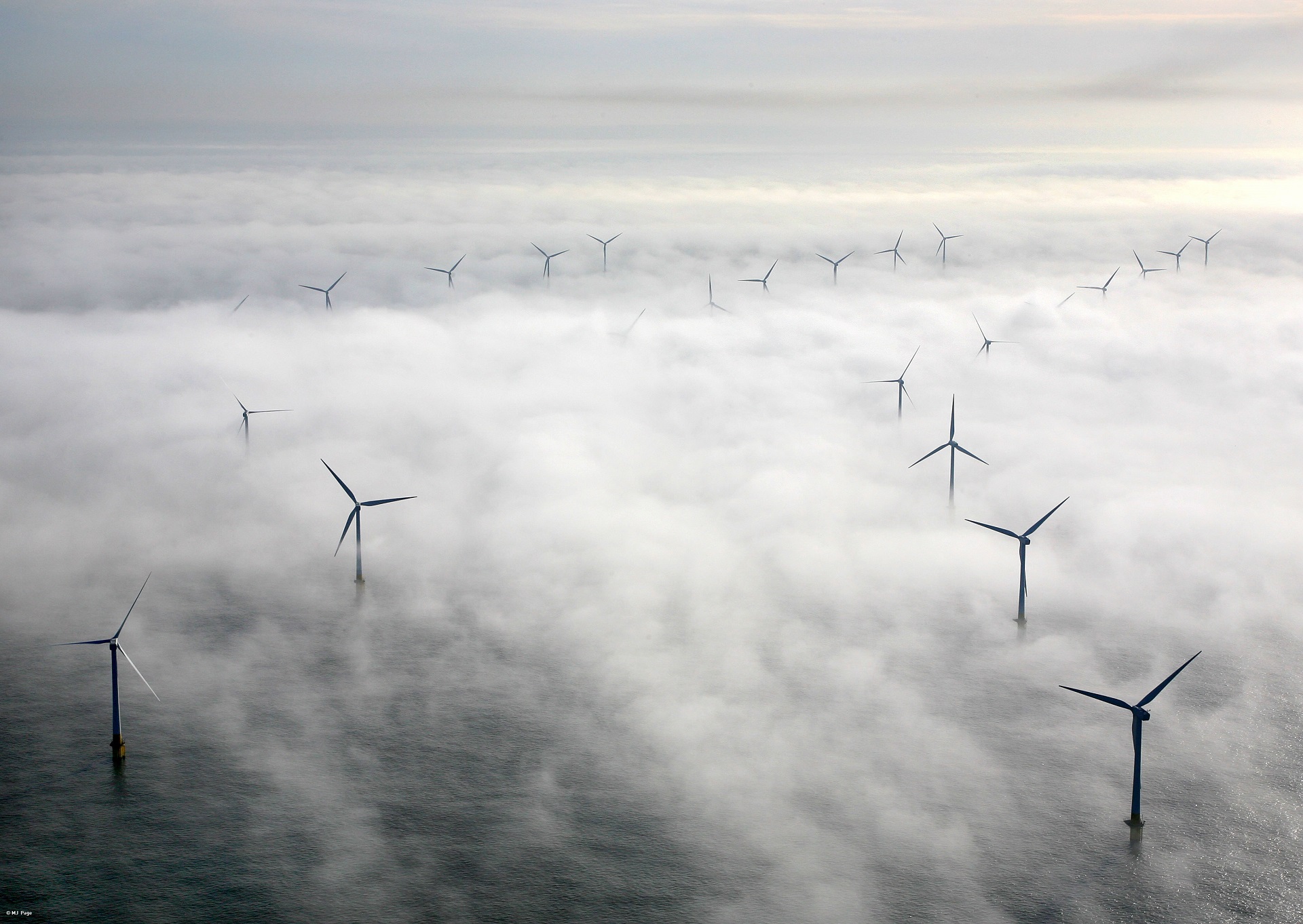 wind farm in sea in mist